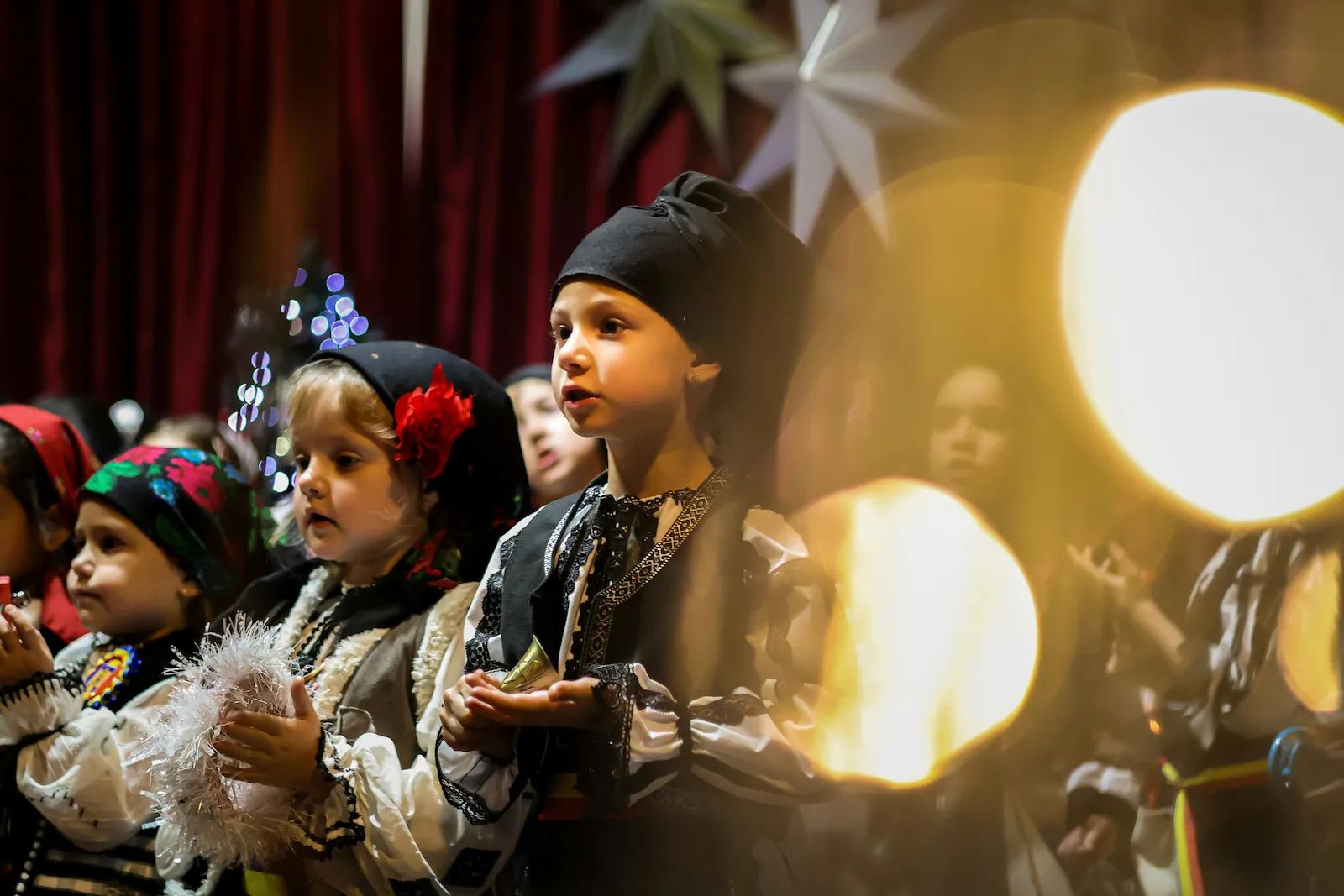 Children in traditional costume singing Christmas carols